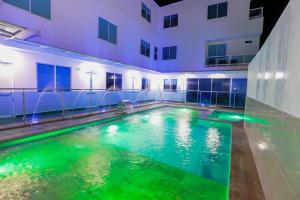 an indoor swimming pool in a building at night at Ocean Blue Beach in San Andrés