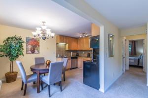 a kitchen and dining room with a table and chairs at the Romeo, Best Area, 2 Bedrooms, WD, Jacuzzi Bath, No Stairs, New Carpet, 825sf in Tacoma