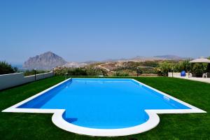 a swimming pool in the middle of a field of grass at Villa Marina in Valderice