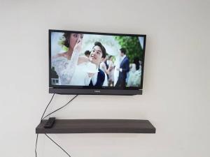 a flat screen tv on a stand on a wall at Pangkor Coral Bay Resort(2 bedrooms) in Pangkor
