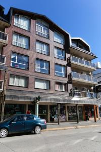 a blue car parked in front of a building at Apart 460 in San Carlos de Bariloche