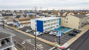 an aerial view of a city with cars parked in a parking lot at AIRE Hotel North Beach Jersey Shore in Seaside Heights