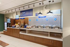 a restaurant with a counter with food on it at Holiday Inn Express & Suites - King George - Dahlgren, an IHG Hotel in Alden