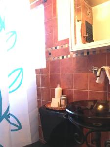 a bathroom with a sink and a mirror at The Jewel of Little Havana - 2S in Miami