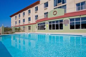 a large swimming pool in front of a building at Holiday Inn Express Hotel & Suites Live Oak, an IHG Hotel in Live Oak