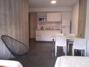 a kitchen with a table and chairs in a room at Pueyrredon 1101 in Rosario