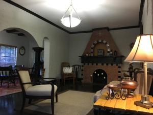 a living room with a fireplace and a table at Private room in the Heart of Little Havana for 4 Guests in Miami