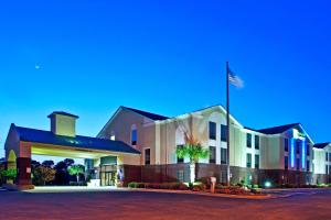 a hotel with an american flag on top of it at Holiday Inn Express & Suites Milton East I-10 by IHG in Milton