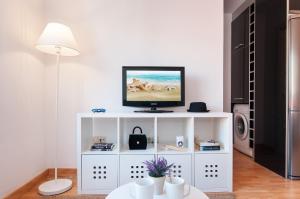 a white entertainment center with a tv on top of it at Triana in Triana