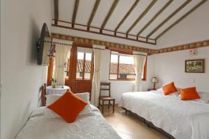 
Ein Bett oder Betten in einem Zimmer der Unterkunft Hotel Villa del Angel
