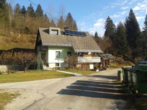 a house with solar panels on the roof at Apartment Žvan in Bohinj