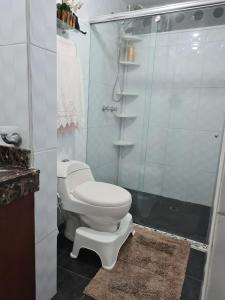 a bathroom with a toilet and a shower at Tu Hogar cerca a la zona T in Bogotá