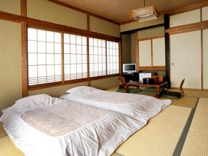 Postel nebo postele na pokoji v ubytování Ryokan Seifuso + 36 fotografií
