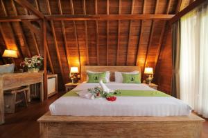 Postel nebo postele na pokoji v ubytování Alam Kawi Ubud Resort & Spa