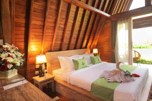Postel nebo postele na pokoji v ubytování Alam Kawi Ubud Resort & Spa