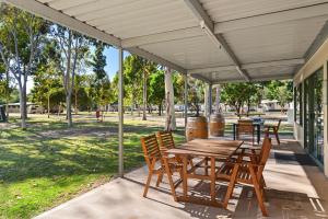 
a patio area with a table, chairs, and a fire hydrant at Discovery Parks - Barossa Valley in Tanunda

