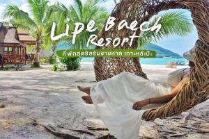 a person laying in a hammock on a beach at Lipe Beach Resort in Ko Lipe