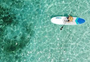 a person on a surfboard in the water at Lipe Beach Resort in Ko Lipe