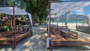 a group of tables and chairs on a beach at Lipe Beach Resort in Ko Lipe