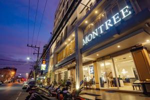 a group of motorcycles parked in front of a store at Montree Phuket Hotel in Phuket Town