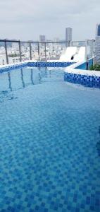 a large swimming pool with blue tiles on a building at Sen Vang Luxury Hotel in Nha Trang