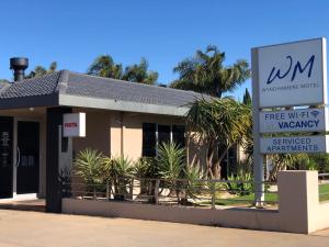 a sign in front of a building with a free wifi innatown at The Wyndhamere Motel Shepparton in Shepparton