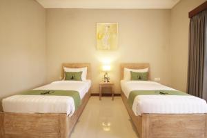 Postel nebo postele na pokoji v ubytování Alam Kawi Ubud Resort & Spa