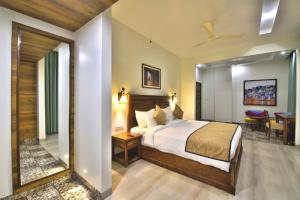 a hotel room with a bed and a table at RUDRA VILAS - A Royal Heritage Hotel in Jaipur