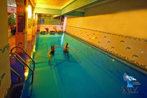 two people are playing in a swimming pool at Krishna Prakash Heritage Haveli in Jodhpur