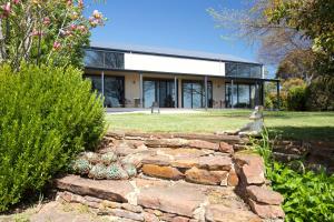 a house with a stone wall in front of a yard at Altitude221 in Mansfield