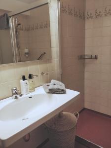 a bathroom with a white sink and a shower at Highway Hotel in Härnösand