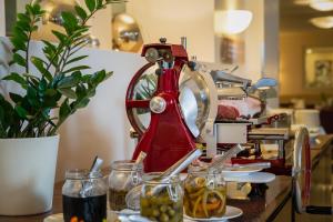 a red mixer sitting on top of a counter at Sandwirth Suites Palais Musil in Klagenfurt