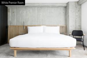 Una cama o camas en una habitación de TUVE Hotel
