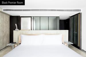 Una cama o camas en una habitación de TUVE Hotel
