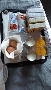 a lunch box with eggs and other food items at Arinza Hotel, London Ilford in Ilford