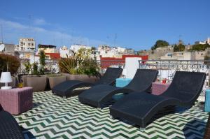 a group of chairs sitting on top of a roof at Tanger Chez Habitant in Tangier