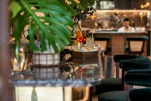 馬略卡島帕爾馬的住宿－帕爾馬套房酒店，餐馆里一个有植物和男人的桌子