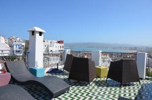 a balcony with chairs and a view of the city at Tanger Chez Habitant in Tangier