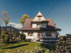 a large white house with a red roof at Apartament u Tomka in Zakopane