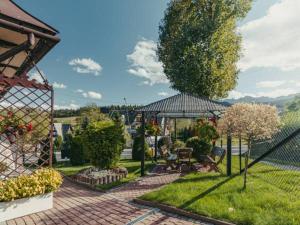 a garden with a pavilion and trees and plants at Apartament u Tomka in Zakopane