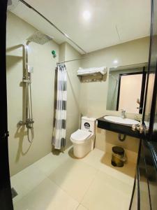 a bathroom with a toilet and a sink and a shower at Phuong Dong Hotel and Apartment in Quy Nhon