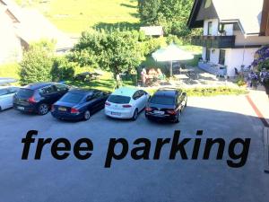a group of cars parked in a parking lot at Apartments & Rooms Preseren in Bled