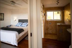 a bedroom with a bed and a bathroom with a sink at Big Sky Cottages in Wolseley