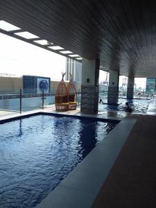 an indoor swimming pool in a building with a building at AJ Sundiva Tower w balcony in Cebu City