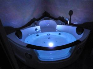 a blue bath tub with a light in a bathroom at Intimo y Acogedor "algunos" con Bañera Hidromasaje in Valencia