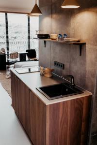 a kitchen with a sink and a counter top at Strandhotel Zoomers in Castricum