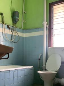 a bathroom with a toilet and a bath tub at Sun Golden Inn in Ipoh
