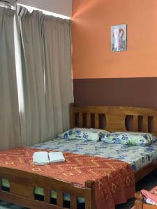 a bedroom with a bed with two towels on it at Sun Golden Inn in Ipoh