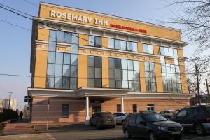 a large building with cars parked in front of it at Rosemary Inn in Saransk
