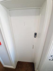 a room with a white wall with a door at Southend on Sea - Westcliff Studios - Great Location in Southend-on-Sea